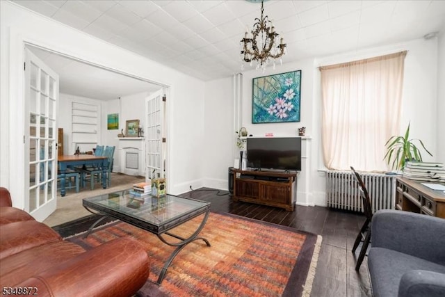 97 N Main St, Lambertville City, NJ 08530 - living room with baseboards, radiator, an inviting chandelier, and wood finished floors