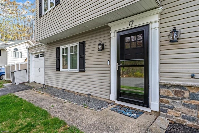 view of exterior entry with aphalt driveway