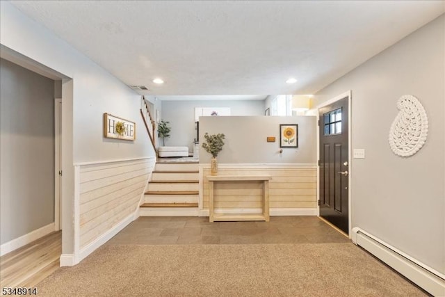 entrance foyer featuring stairs, recessed lighting, baseboards, and a baseboard heating unit