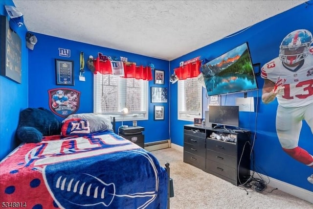 carpeted bedroom with a textured ceiling, a baseboard heating unit, and baseboards
