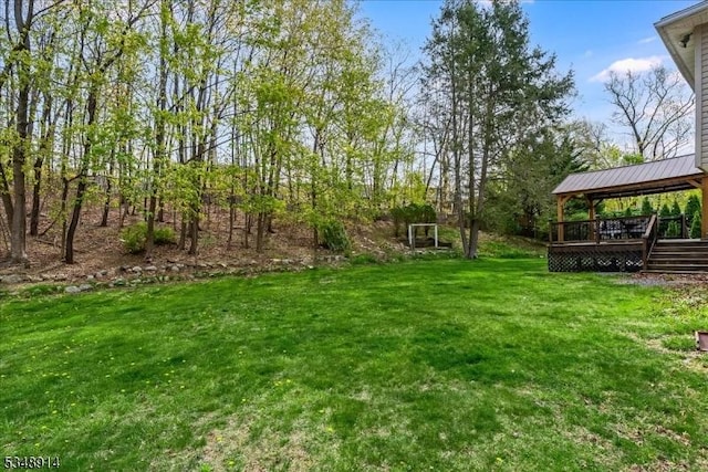 view of yard with a wooden deck and a gazebo