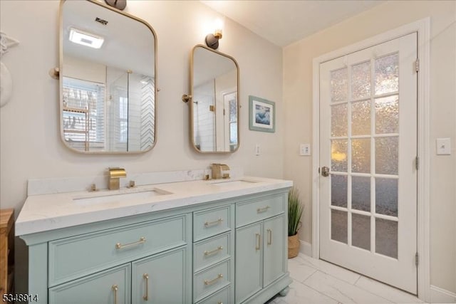 bathroom featuring a sink, baseboards, double vanity, and marble finish floor