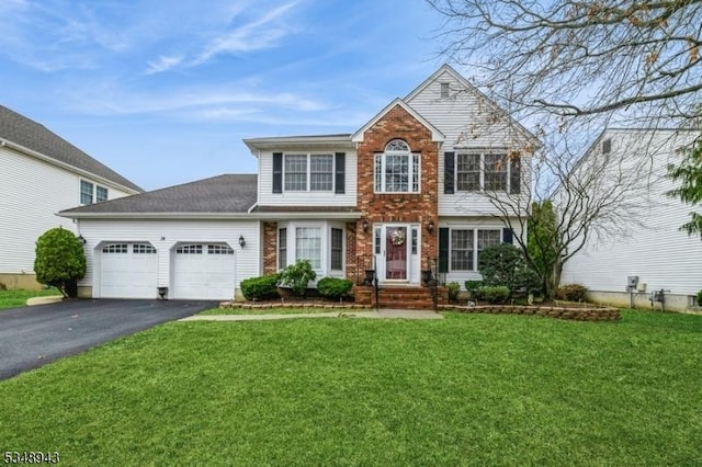 view of front facade featuring brick siding, an attached garage, a front lawn, and aphalt driveway