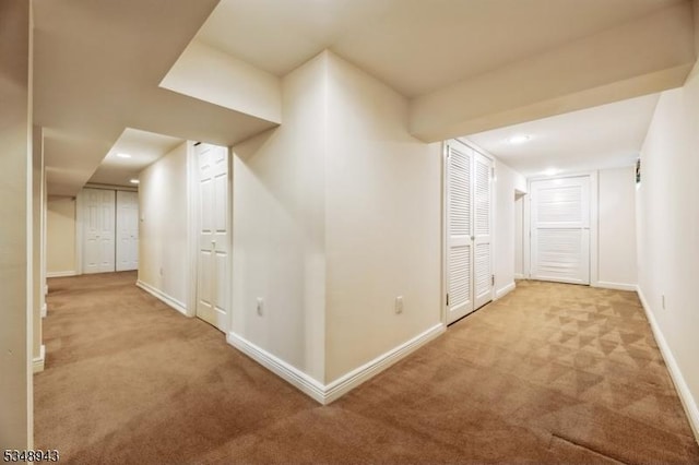 hall featuring carpet floors, baseboards, and recessed lighting