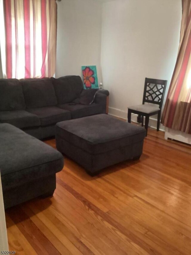 living area featuring baseboards and light wood-style flooring