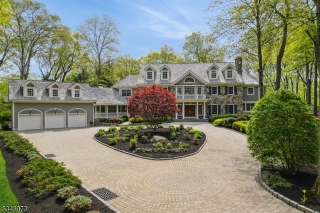 2 Queens Ct, Mendham Twp, NJ 07960 - view of front facade with curved driveway, a garage, and a chimney