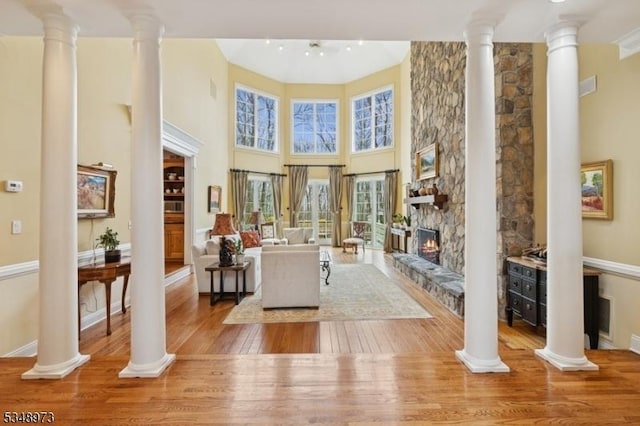 2 Queens Ct, Mendham Twp, NJ 07960 - living room with hardwood / wood-style floors, decorative columns, a fireplace, and a towering ceiling