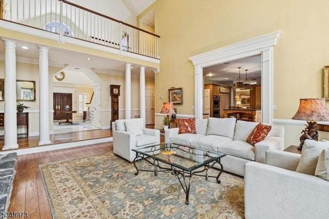 2 Queens Ct, Mendham Twp, NJ 07960 - living area with decorative columns, hardwood / wood-style flooring, high vaulted ceiling, and a chandelier