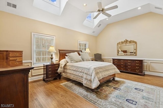 2 Queens Ct, Mendham Twp, NJ 07960 - bedroom with a skylight, vaulted ceiling, wood finished floors, a wainscoted wall, and a ceiling fan