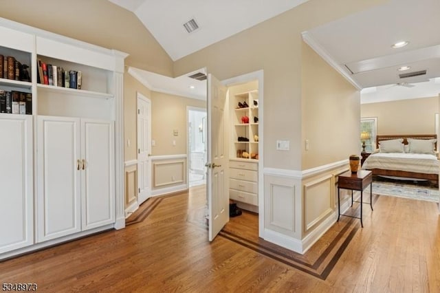 2 Queens Ct, Mendham Twp, NJ 07960 - corridor with light wood-style floors, a wainscoted wall, a decorative wall, lofted ceiling, and built in shelves
