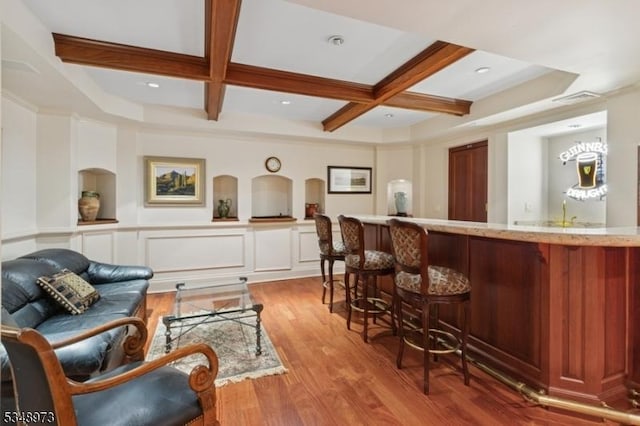 2 Queens Ct, Mendham Twp, NJ 07960 - living area with coffered ceiling, wet bar, wood finished floors, beamed ceiling, and ornamental molding