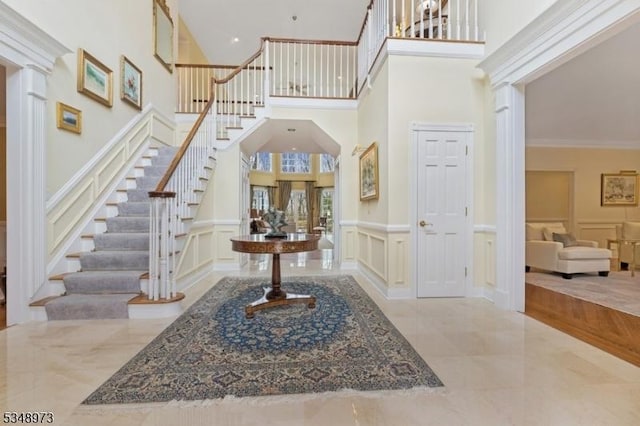2 Queens Ct, Mendham Twp, NJ 07960 - entryway with a decorative wall, decorative columns, stairway, crown molding, and a wainscoted wall