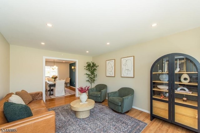 living room featuring light wood-style floors, recessed lighting, and baseboards