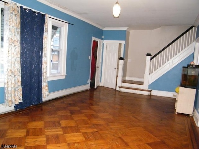 foyer entrance featuring baseboards, ornamental molding, and stairway
