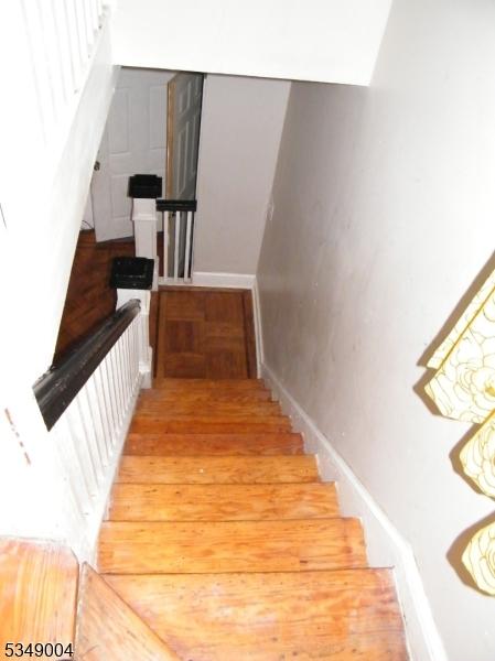 stairs featuring baseboards and wood finished floors