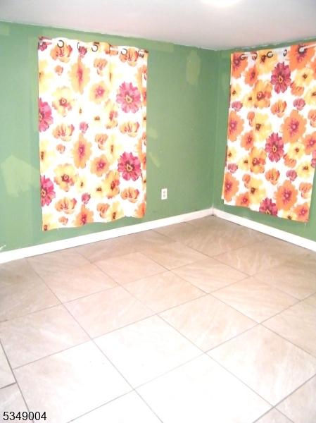 tiled empty room with baseboards