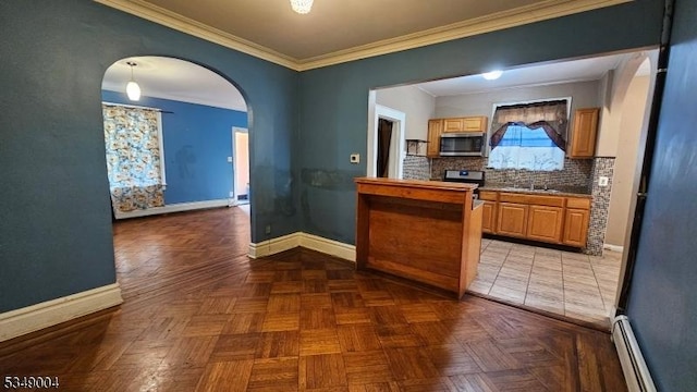 kitchen with baseboards, arched walkways, appliances with stainless steel finishes, and baseboard heating
