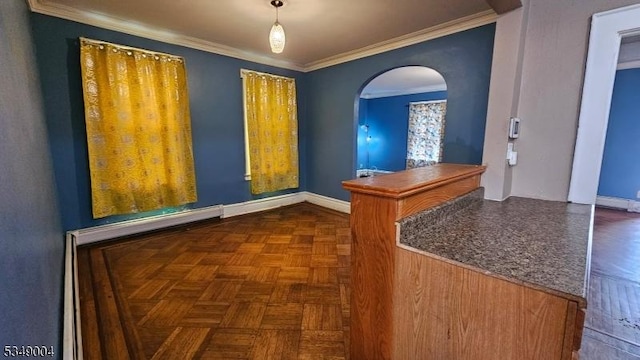 entryway with crown molding, arched walkways, baseboards, and a baseboard radiator