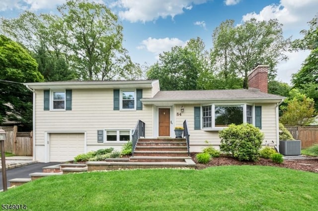 84 Burnham Pkwy, Morris Twp, NJ 07960 - split level home featuring a garage, a chimney, and asphalt driveway