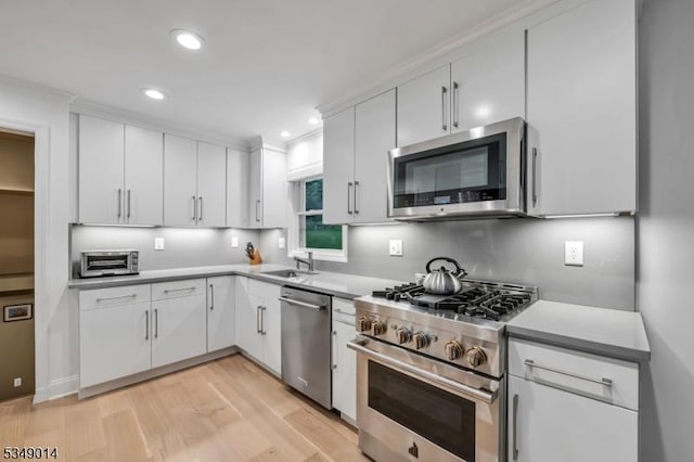 84 Burnham Pkwy, Morris Twp, NJ 07960 - kitchen with appliances with stainless steel finishes, light wood-type flooring, recessed lighting, white cabinetry, and light countertops