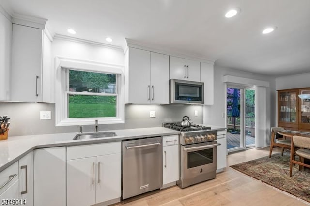 84 Burnham Pkwy, Morris Twp, NJ 07960 - kitchen with stainless steel appliances, white cabinets, light wood-style flooring, and recessed lighting