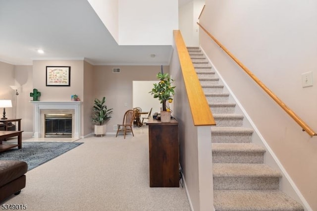 stairway featuring crown molding, carpet floors, recessed lighting, baseboards, and visible vents