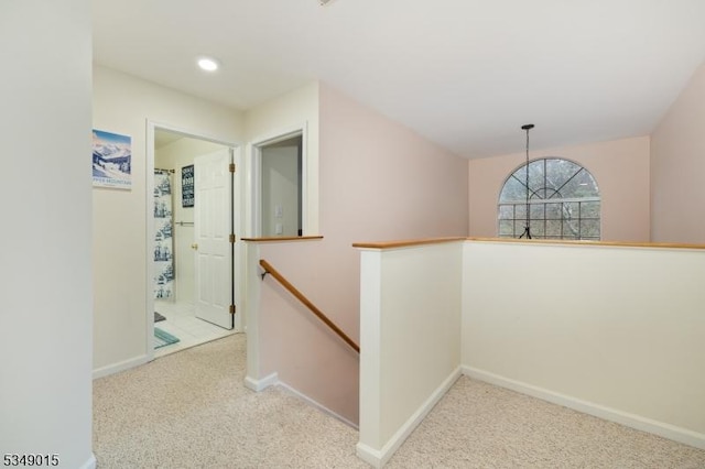 hallway featuring baseboards, carpet, recessed lighting, and an upstairs landing