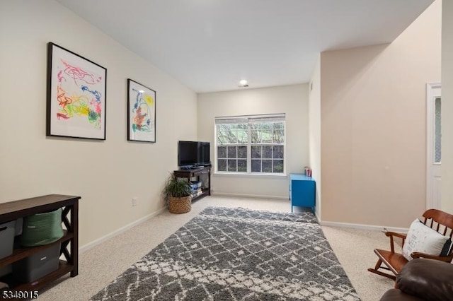 sitting room with baseboards and carpet
