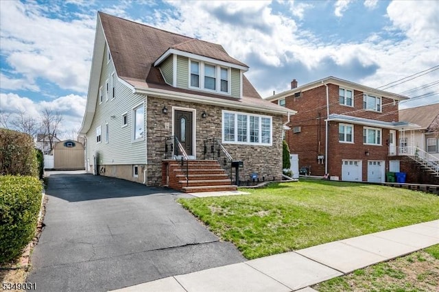 view of front of house featuring stone siding and a front lawn