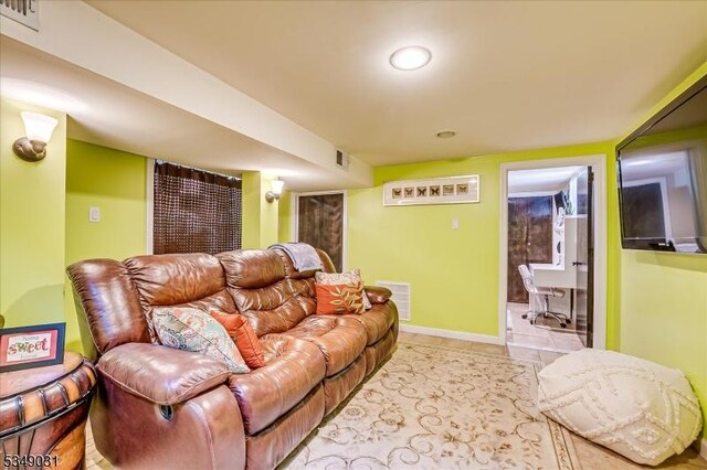tiled living room featuring baseboards and visible vents