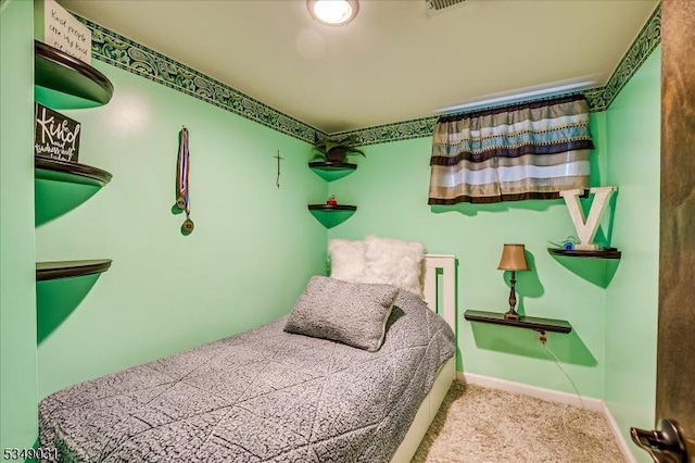 carpeted bedroom featuring baseboards and visible vents