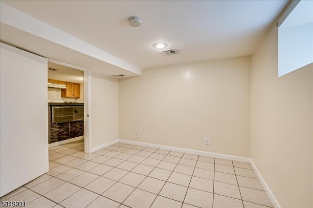 unfurnished room with light tile patterned flooring, baseboards, and visible vents
