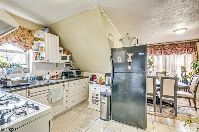 kitchen featuring white cabinets, open shelves, white appliances, and plenty of natural light