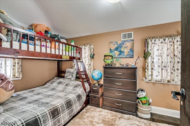 bedroom with baseboards and visible vents