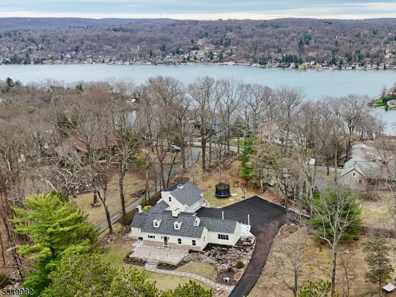 aerial view with a water view and a forest view