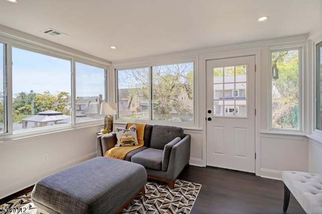 sunroom with recessed lighting, visible vents, plenty of natural light, and wood finished floors