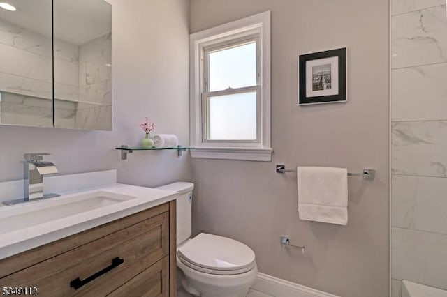 bathroom with vanity, baseboards, a shower, and toilet
