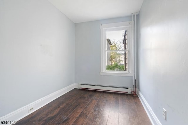 unfurnished room with baseboards, a baseboard heating unit, and dark wood-style flooring