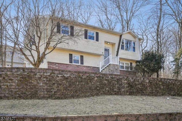 raised ranch featuring brick siding