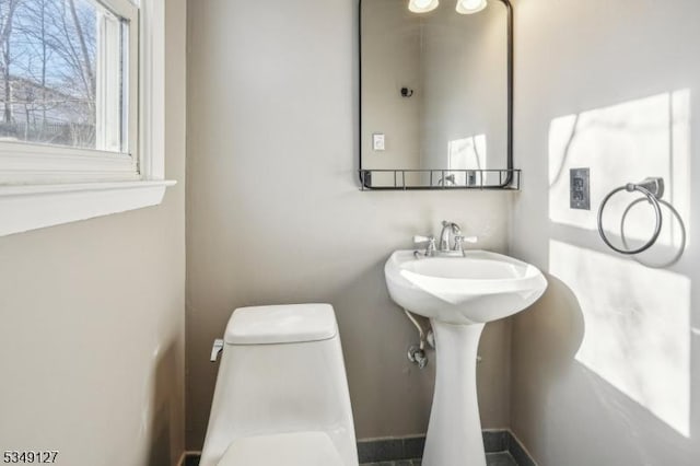 bathroom featuring toilet and a sink