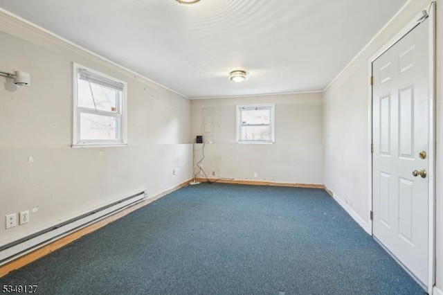 carpeted spare room with a baseboard radiator, crown molding, and baseboards