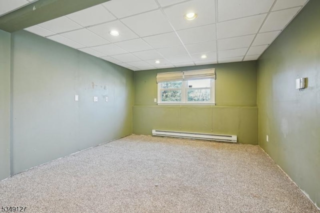 below grade area featuring recessed lighting, a paneled ceiling, baseboard heating, and carpet floors