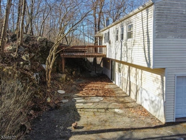 view of side of home with a wooden deck