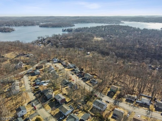 birds eye view of property with a water view and a view of trees
