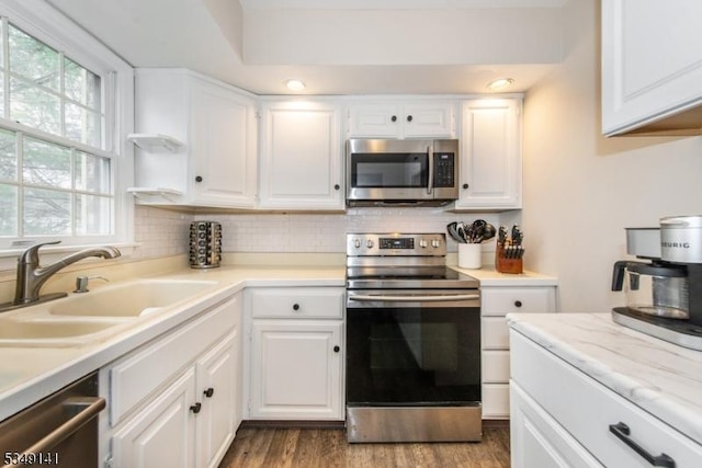107 S Maple, Park Ridge Boro, NJ 07656 - kitchen with stainless steel appliances, white cabinetry, a sink, and backsplash