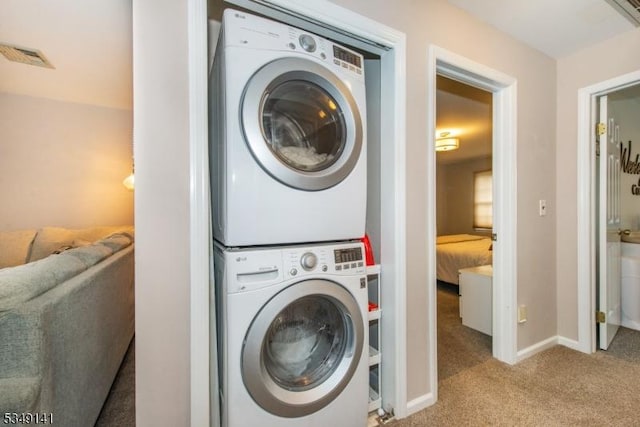 107 S Maple, Park Ridge Boro, NJ 07656 - laundry area featuring visible vents, baseboards, stacked washer and clothes dryer, laundry area, and carpet flooring