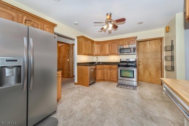 11 Stillwell Rd, South Brunswick Twp, NJ 08824 - kitchen featuring stainless steel appliances, ceiling fan, a sink, dark countertops, and brown cabinets
