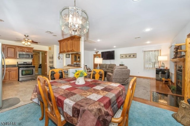 11 Stillwell Rd, South Brunswick Twp, NJ 08824 - dining space featuring a glass covered fireplace, recessed lighting, a chandelier, light carpet, and ceiling fan