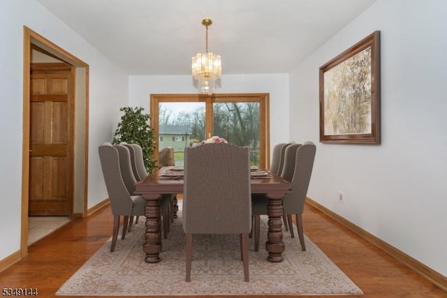 11 Stillwell Rd, South Brunswick Twp, NJ 08824 - dining area with a chandelier, baseboards, and wood finished floors