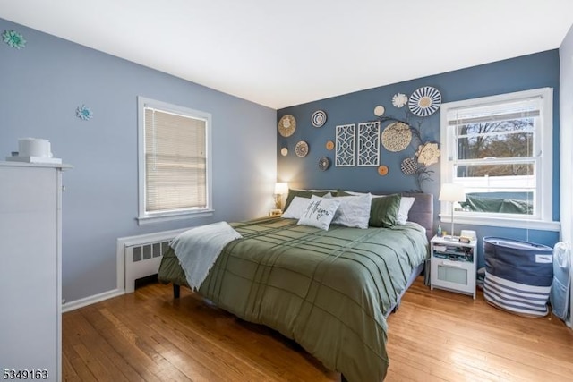 bedroom featuring radiator and wood-type flooring